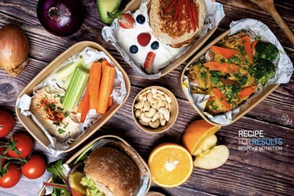 Healthy Meal Prep selection including hummus and veggies, protein pancakes with yogurt and berries, homemade burgers and Katsu chicken curries - Recipe For Results, Essex