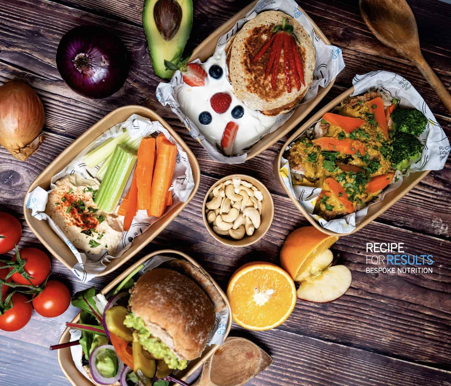 Healthy Meal Prep selection including hummus and veggies, protein pancakes with yogurt and berries, homemade burgers and Katsu chicken curries - Recipe For Results, Essex