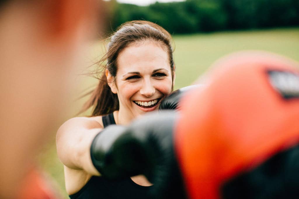 Outdoor personal training session in Essex showing a client performing boxing-inspired core twists with pads. Functional, engaging, and results-driven training from Recipe For Results.